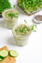 smoothie of micro-green apples cucumber and spinach on a light background. eco organic fresh food detox . ingredients fresh micro-greens . close-up selective focus