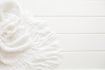 Obraz premium A white knitted dress lies on a white wooden deck chair. Swimwear, leisure wear. Vacation concept on the beach, with copy space and place for text.