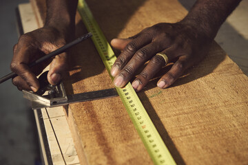 close up of a carpenter working on a wooden board