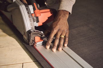 close up of hands working on a saw