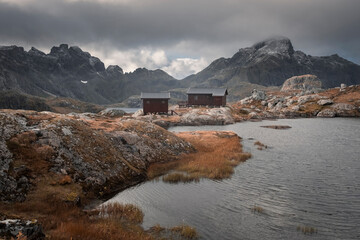 Lofoten Islands Norway. Mountain autumn landscape. Hike to Mount Munken, wooden houses, a shelter and a lake in deep autumn