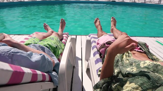 Young men chilling on the sun lounger