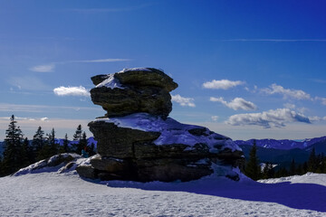 huge rock with snow and beautiful blue sky