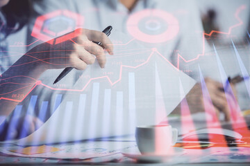 Double exposure of forex graph drawing over people taking notes background. Concept of financial analysis