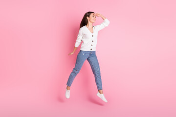 Full body photo of happy cheerful positive young woman jump up hand head look empty space isolated...