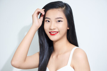 Young beautiful Asian woman with smiley face isolated on white background.
