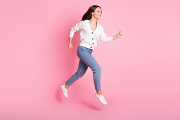 Full size profile side photo of cheerful happy young lady jump up run empty space sale isolated on pink color background