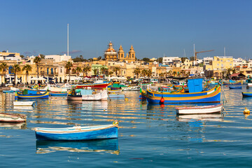 Fototapeta na wymiar Traditional fishing boats in the Mediterranean Village of Marsaxlokk, Malta