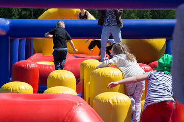 Colorful inflatable attractions on the open air playground