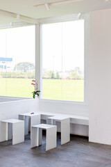 White room and entry-colored table with large windows.
