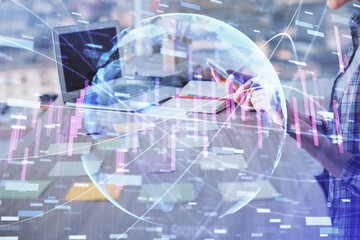 Double exposure of woman hands working on computer and forex graph hologram drawing. Financial analysis concept.