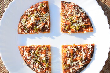 Farali pizza made out of Fasting flour eaten during Indian fast with fasting ingredients topped...