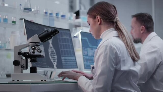 Female doctor working in laboratory. Studying human skeleton dna DNA samples