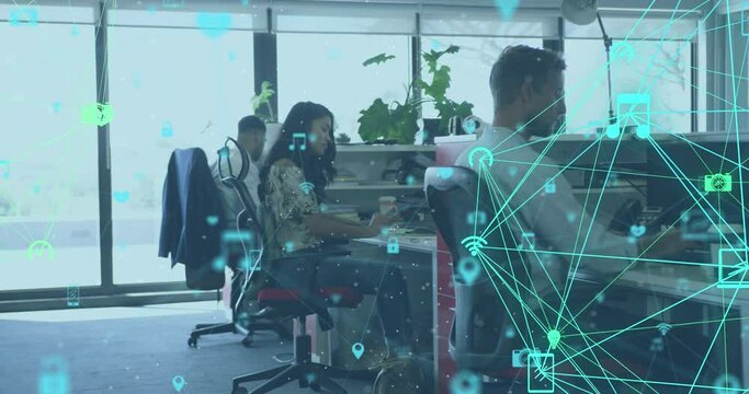Animation of a network of connected media icons with business colleagues working in creative office