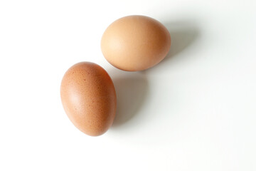 minimalism food photography, raw fresh brown egg on white background