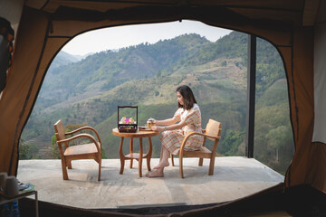 beautiful women drinking hot green tea sitting on the chair mountain view