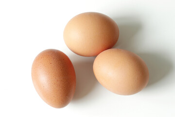 minimalism food photography, raw fresh brown egg on white background