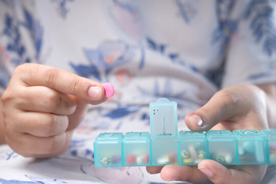 Women Hands Taking Medicine From A Pill Box 