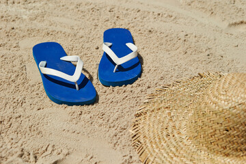 Fototapeta na wymiar Straw hats and accessories on the beach sand