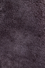Background. Texture. Short wool of a coffee-colored sheep. Vertical orientation, close-up.