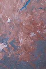 Background.Texture. A piece of wall with red and blue plaster. Vertical orientation. Close-up.