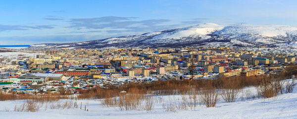 Panorama of the city of Magadan. Top view of the northern city, located among the mountains. Beautiful cityscape with many buildings. Magadan, Magadan Region, Siberia, Far East Russia. Panoramic photo