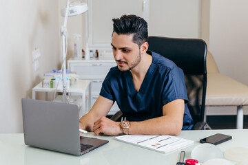 A young arabic or turkish doctor in a blue uniform conducts online counseling