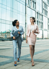Business people walking and talking in the street