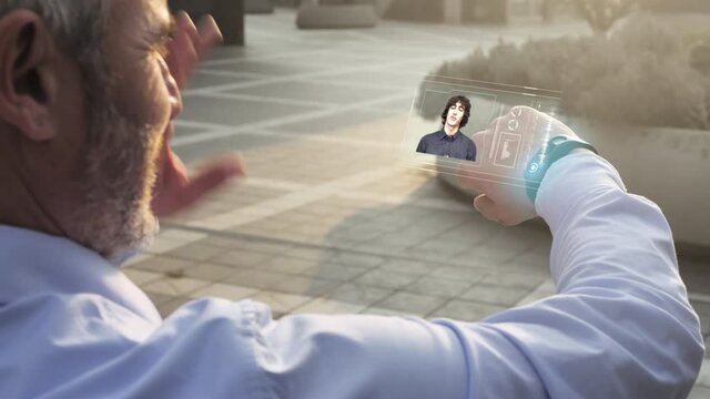 business man turns on virtual holographic screen from smartwatch to join video conference work call,businessman using futuristic glass smart phone with augmented reality technology - Powered by Adobe