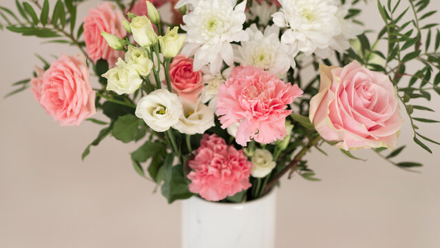 Bouquet of fresh spring flowers on light pink wall background
