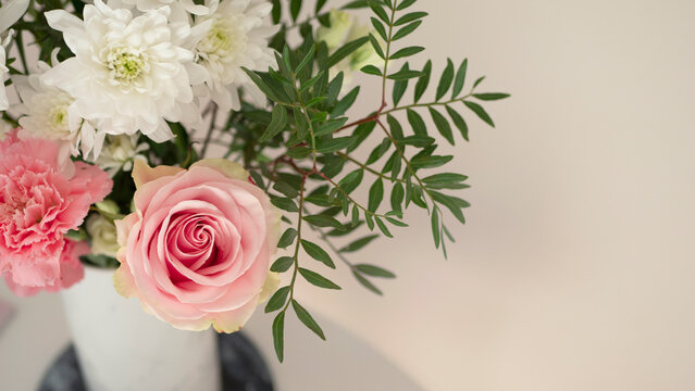 Bouquet of fresh spring flowers on light pink wall background
