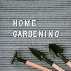 letterboard with text Home gardening and garden tools: shovel, rake