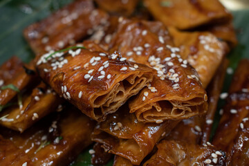 Tofu skins yuba rolls glazed and roasted, served with rice, edamame