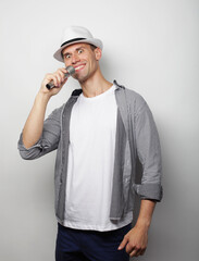 young handsome man singing with microphone