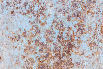 Oxidized rough texture, brown rust with peeling blue paint. Rusty metal surface, not painted, outdoors, close-up photo.