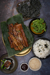 Tofu skins yuba rolls glazed and roasted, served with rice, edamame