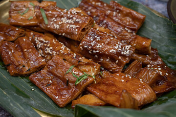 Tofu skins yuba rolls glazed and roasted, served with rice, edamame