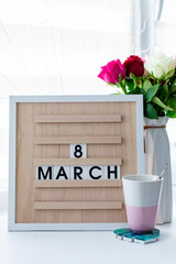 Women's Day is March 8 with a calendar board and fresh flowers. Calendar with the date March 8 - the Festival of colors