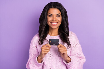 Photo of young beautiful lovely positive good mood afro girl hold show credit card isolated on...