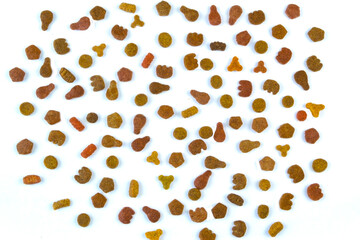 Cat dry food is laid out on one cracker on a white background.