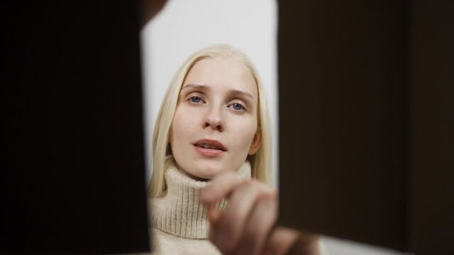 Close up inside of carton box bottom view, woman opens parcel looks at delivered goods items feels happy.