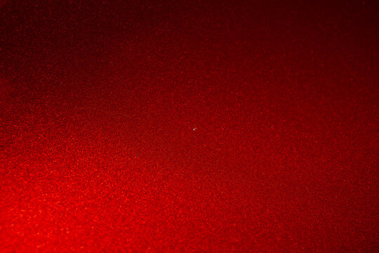 Close up of red metallic car paint surface wallpaper background