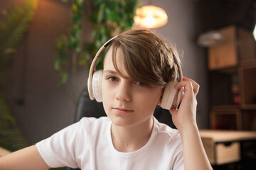 Little boy wearing headphones during online education course, lesson, view of screen. Using headphones. Easy, comfortable usage concept, education, online, childhood, modern technologies for remotion.