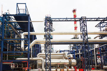 Fototapeta na wymiar Close-up of pipelines and destillation tanks of an oil-refinery plant
