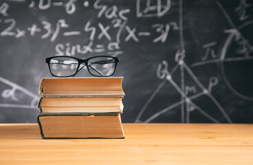glasses on book with chalkboard