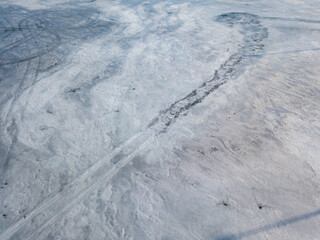 Frosty pattern on ice. Aerial drone top view. Sunny winter day.