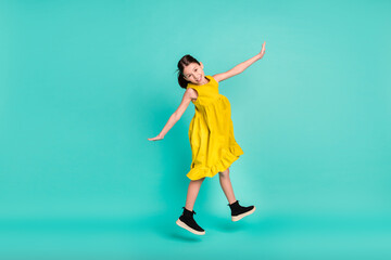 Full size profile photo of optimistic nice brown hair girl jump wear yellow dress isolated on bright teal color background