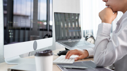 Asian Woman programmer typing source codes Programming On Computer in office, freelance web...