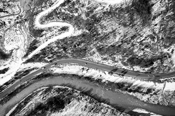 Obraz premium Aerial view on mountain road from drone in winter.