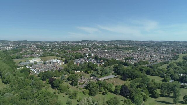 Aerial of a sunny Exeter city, England. Vast open inner city green spaces